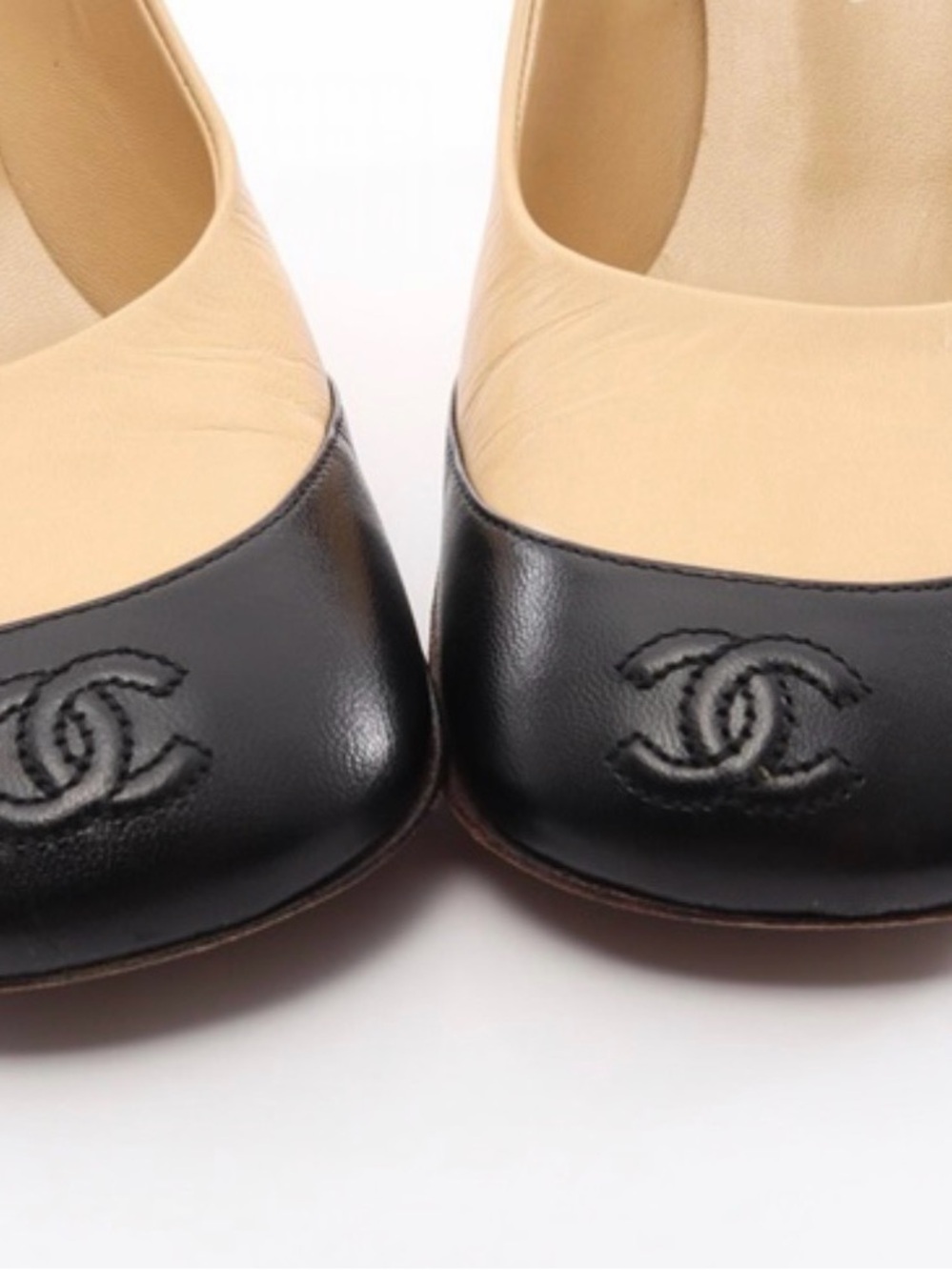 CHANEL Two-Tone Leather Cap-Toe Ballet Flats in Black and Beige